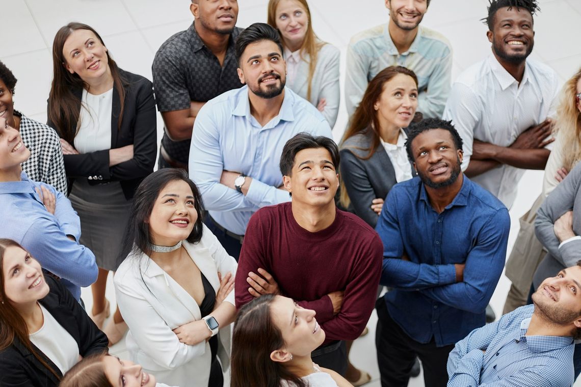Group of successful business people looking up